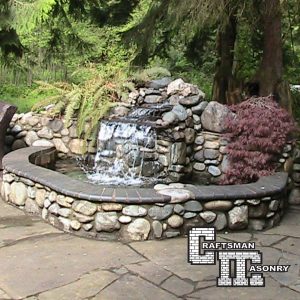 High end patio and outdoor kitchen by Craftsman Masonry INC